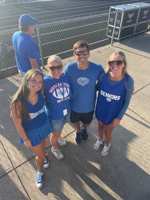 The Wright family in HSE blue at a Friday night football game.